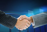 Composite image of business handshake against glowing