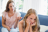 Girl not talking after an argument with mother in living room