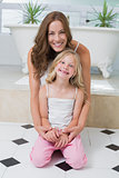 Portrait of smiling mother and daughter in the bathroom