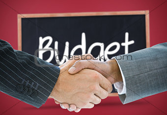 Composite image of business handshake against budget