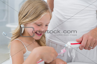 Close-up of mother with daughter brushing teeth