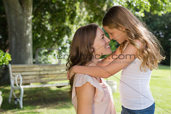 Smiling young girl and mother at the park