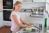Portrait of a young girl standing near kitchen