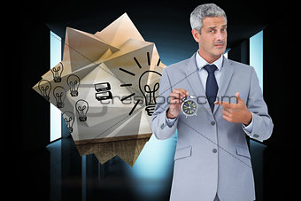 Composite image of businessman holding alarm clock