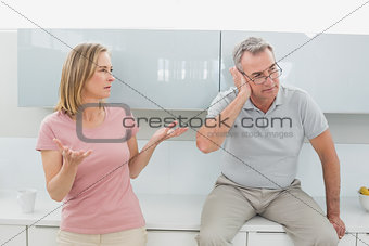 Couple having an argument in kitchen