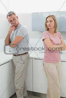 Unhappy couple not talking after an argument in kitchen