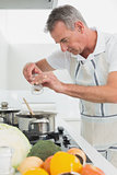 Side view of a man preparing food in kitchen