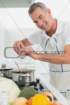 Side view portrait of a man preparing food in kitchen