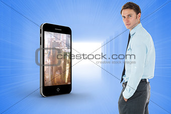 Composite image of serious businessman standing with hands in pockets