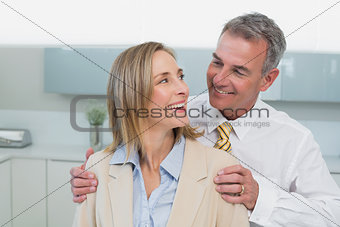 Happy business couple in kitchen