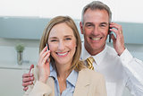 Portrait of a business couple using cellphones