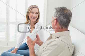 Relaxed couple with coffee cup in living room