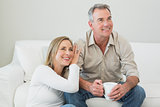 Couple with coffee cup in living room
