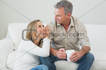 Couple with coffee cup in living room