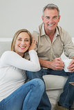Portrait of couple with coffee cup in living room