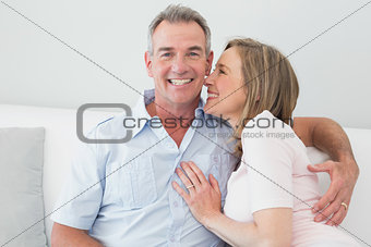 Portrait of a happy couple embracing in living room