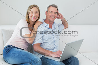 Portrait of a relaxed couple using laptop at home