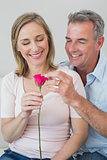 Happy romantic couple with a flower