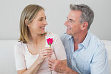 Happy romantic couple with a flower