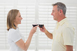 Side view of a couple toasting wine glasses