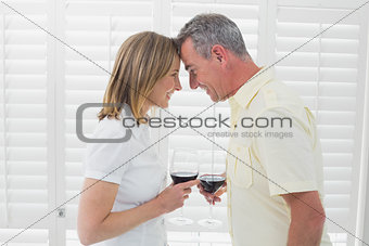 Side view of a couple toasting wine glasses