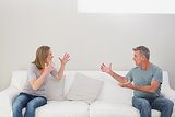 Unhappy couple having an argument in living room
