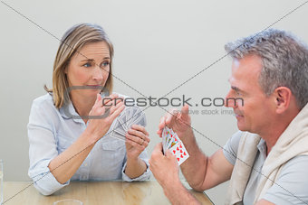 Couple playing cards at home