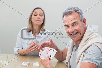Couple playing cards at home
