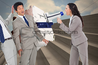 Composite image of businesswoman with megaphone yelling at colleagues