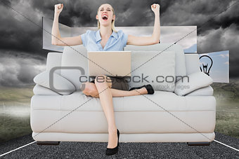 Composite image of cheering beautiful businesswoman sitting on couch