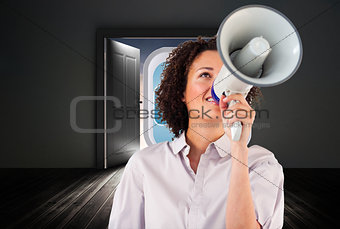 Composite image of businesswoman shouting through megaphone