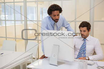 Businessmen working on computer in office