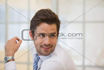 Smiling businessman looking away in office
