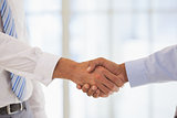 Close-up shot of a handshake in office