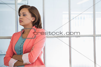 Serious businesswoman looking away at office