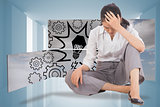 Composite image of depressed businesswoman sitting with hand on head