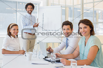 Businessman giving presentation to colleagues in office