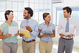 Business colleagues holding folders in office