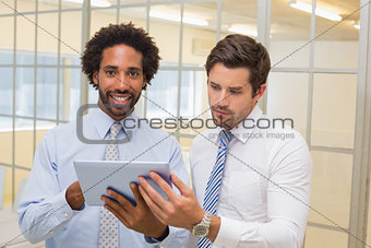 Young businessmen with digital tablet in office