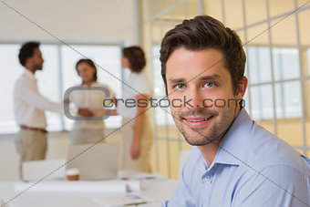 Businessman with colleagues hand shaking at office