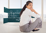 Composite image of businesswoman sitting cross legged smiling