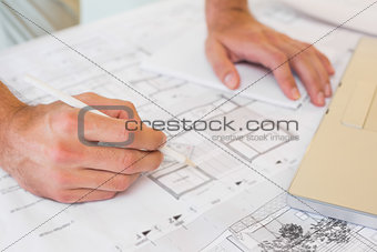 Hands working on blueprints