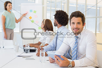 Young businessman with colleagues in boardroom meeting