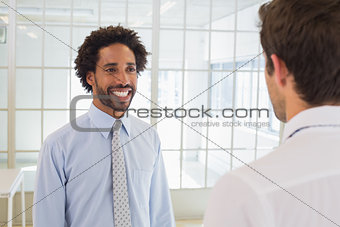 Businessmen looking at each other in office