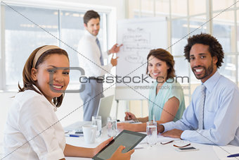 Businessman giving presentation to colleagues in office