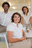 Smiling businesswoman with colleagues at office