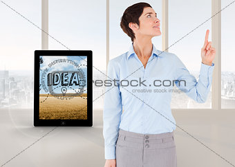Composite image of businesswoman pointing up