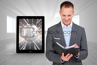 Composite image of arttractive businessman consulting his agenda