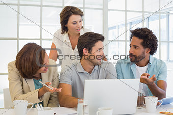 Business people using laptop at office