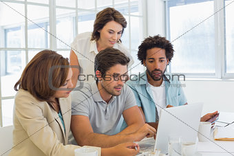 Business people using laptop at office
